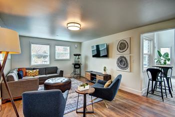 A living room with couches and chairs and a table